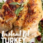 Cooked Instant Pot turkey breast on a bed of herbs and garnished with sage. A text overlay reads "Instant Pot Turkey Breast."