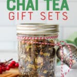 A glass jar filled with loose leaf is tied to a tea ball with baker's twine. The jar is surrounded by spices. A text overlay reads "Homemade Chai Tea Gift Sets."