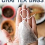 A hand holds a tea bag filled with homemade chai tea blend. A text overlay reads "How to Make Chai Tea Bags."