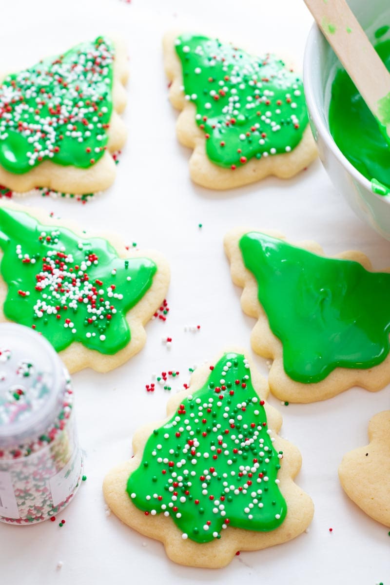 Iced sugar cookies get garnished with sprinkles.