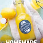 A full and labeled bottle of Homemade Limoncello lies on a white kitchen towel among lemons and other filled bottles. A text overlay reads "Easy Holiday Gift! Homemade Limoncello."