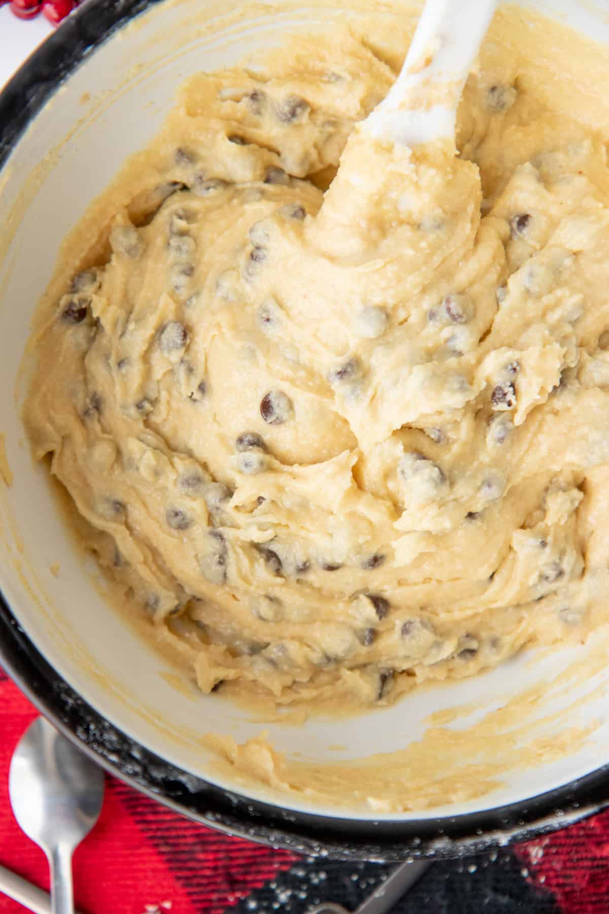 Close up on a mixing bowl full of eggless chocolate chip cookie dough.