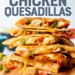Chicken quesadillas are stacked on top of a wooden cutting board. Text overlay reads, "The best ever! Chicken Quesadillas."
