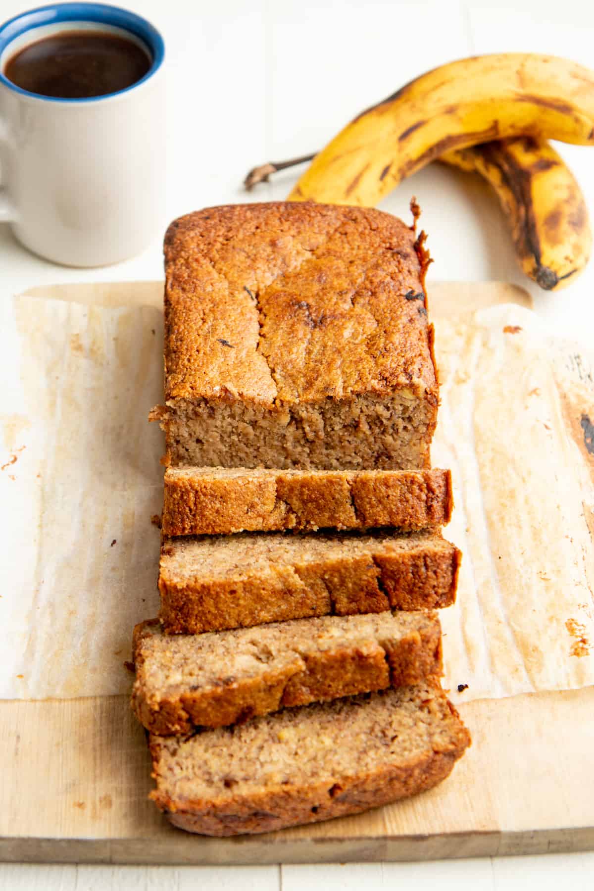 A loaf of almond flour banana bread is cut into slices.