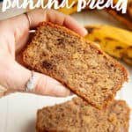 A woman's hand holds a slice of paleo banana bread over a stack of other slices. A text overlay reads "Paleo Banana Bread."