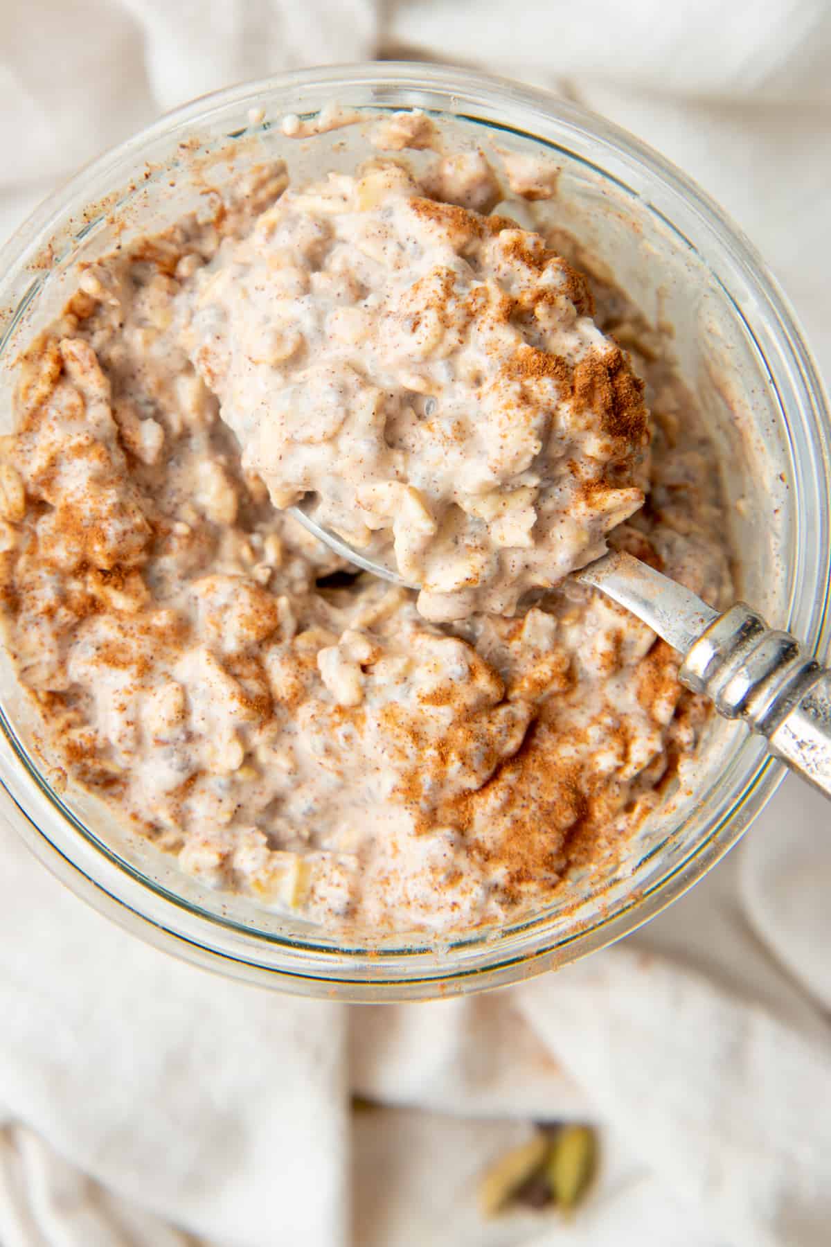 A spoon scoops out a bite of chai overnight oats.