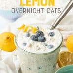 A spoon sits in a jar of blueberry overnight oats. A text overlay reads "Blueberry Lemon Overnight Oats."