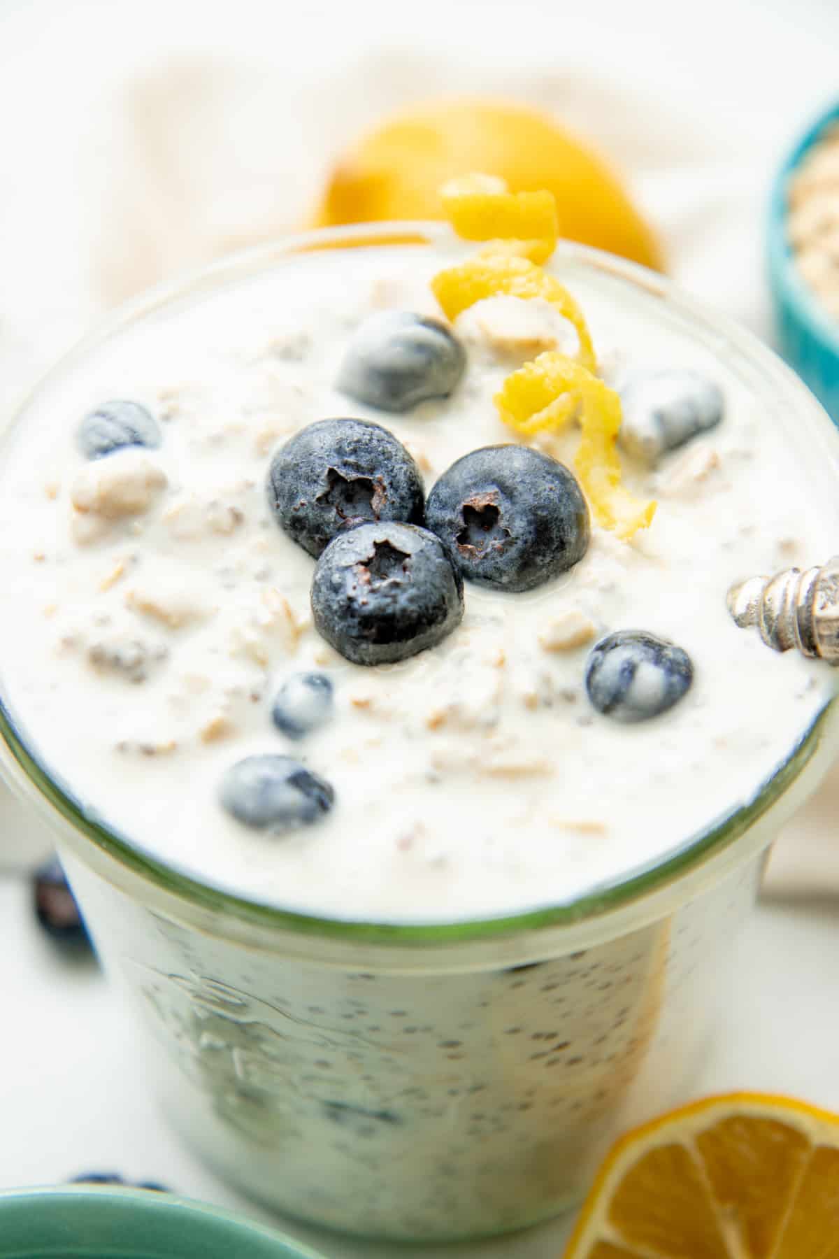 Overnight oats are topped with blueberries and a twist of lemon.