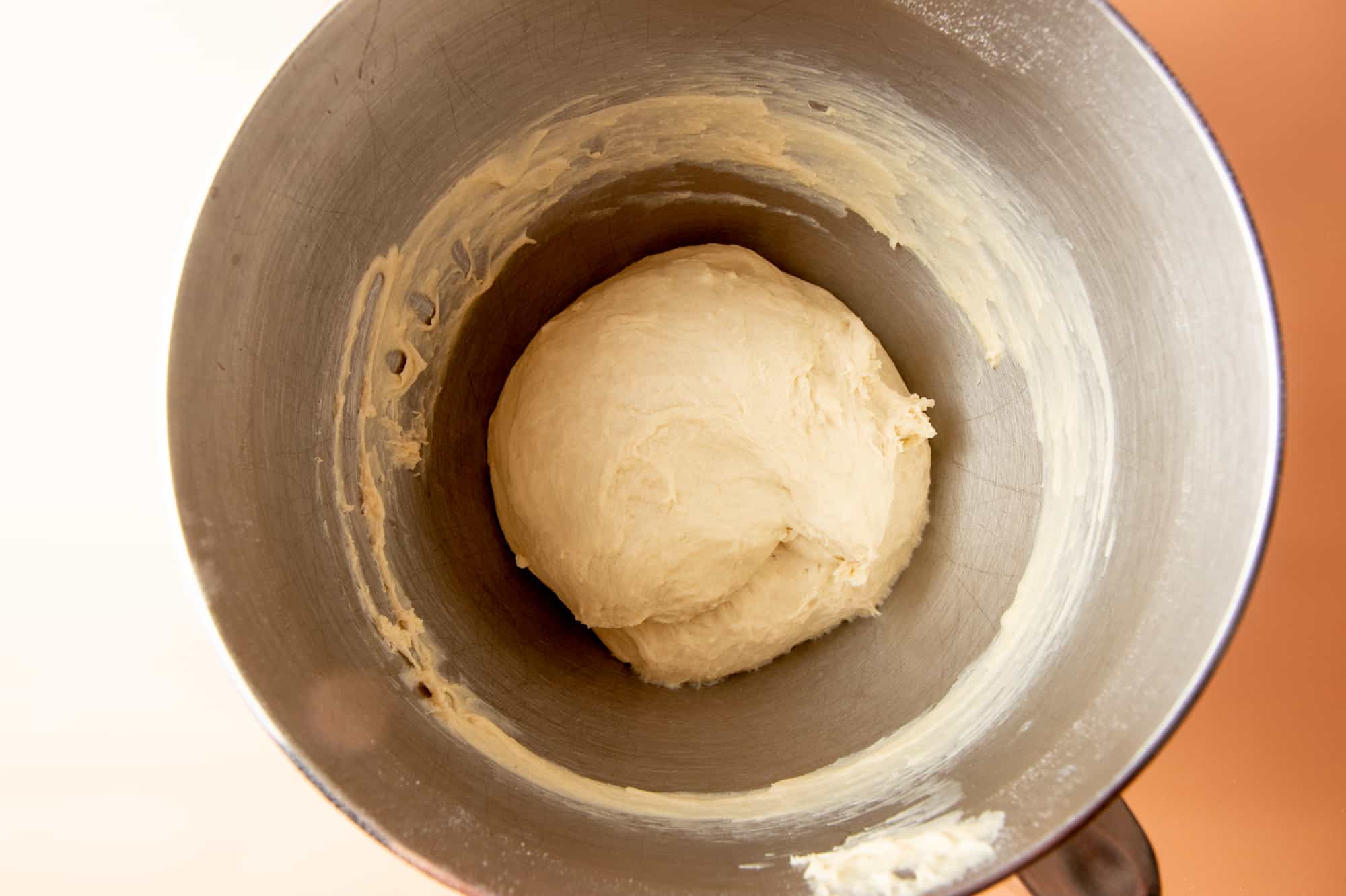 A ball of dough sits inside the mixer.