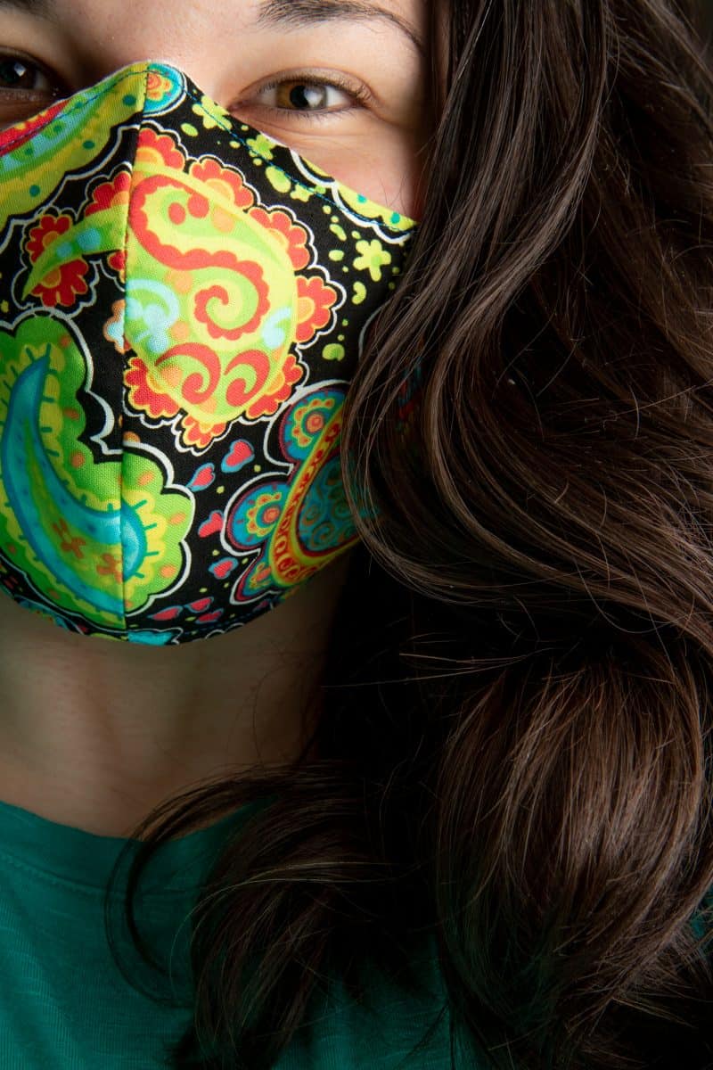 A woman wears the finished face mask.