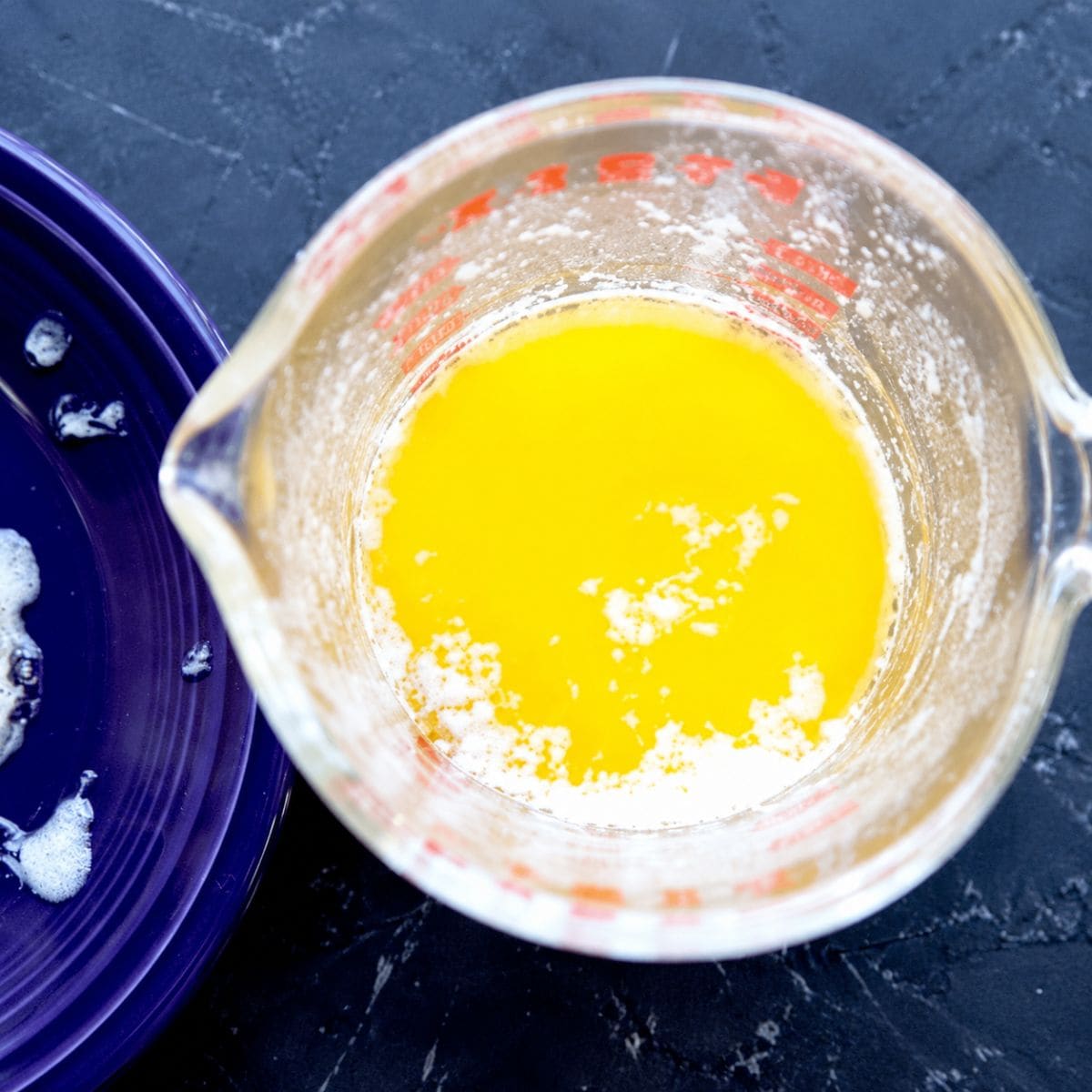 Clarified butter in a measuring cup