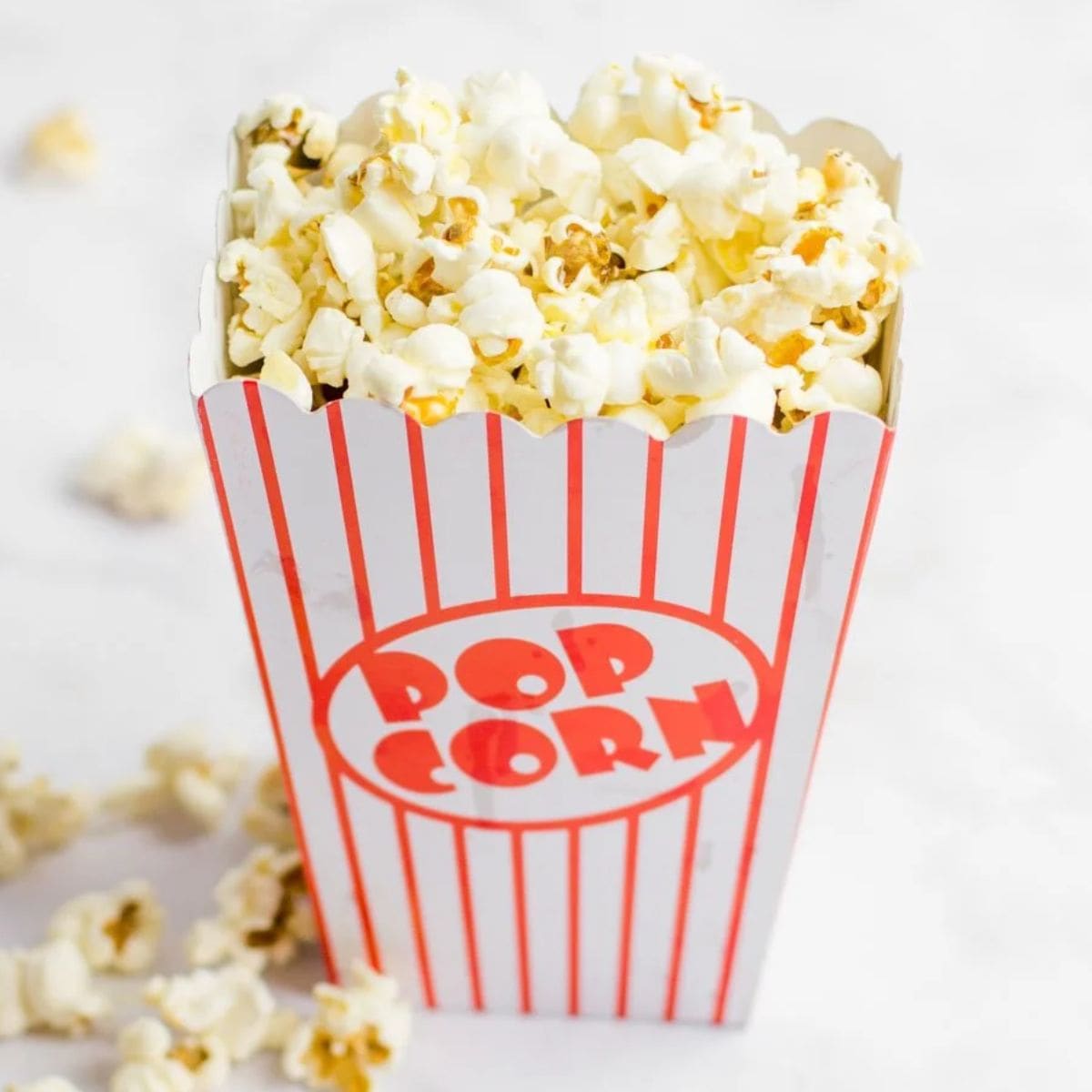 Movie theater popcorn in a red and white striped box