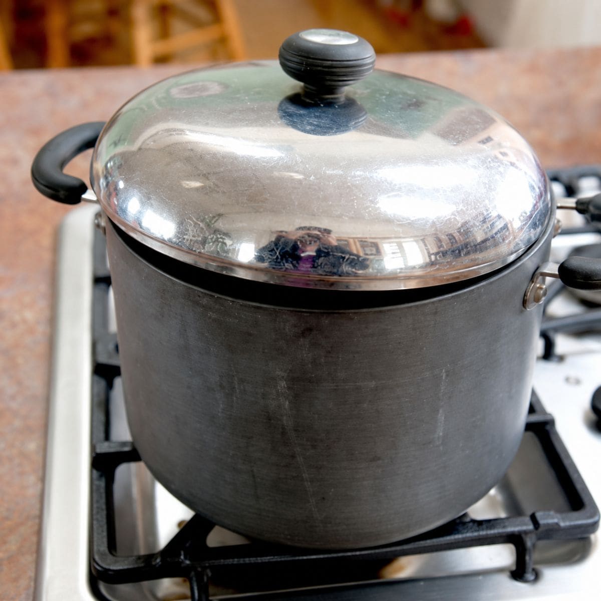 Lid ajar on a pot of popping popcorn