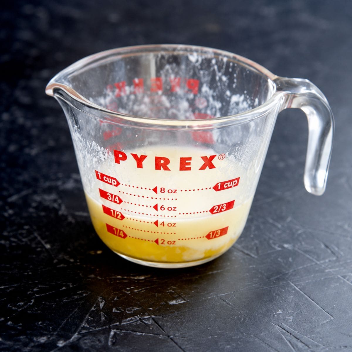 Melted butter in a glass measuring cup