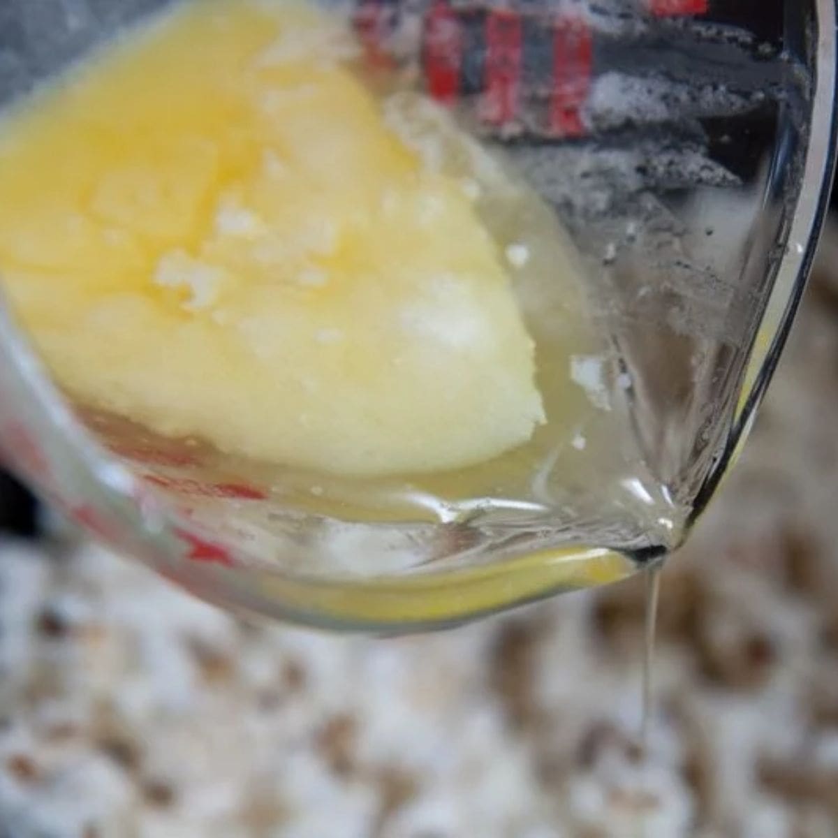 Pouring clarified butter onto popcorn