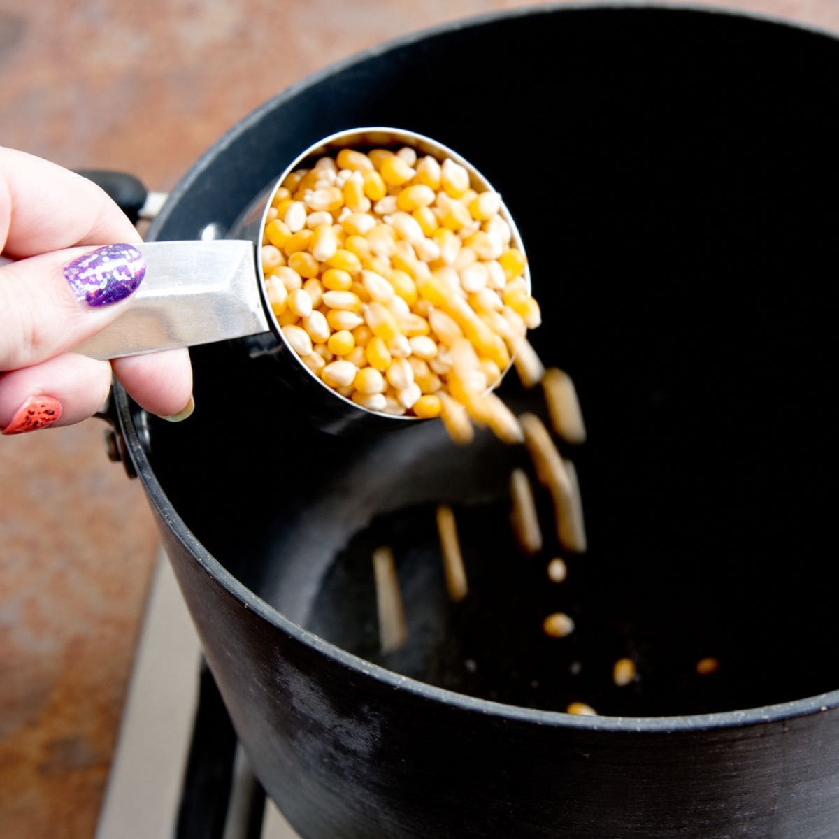 Adding unpopped popcorn to a pot
