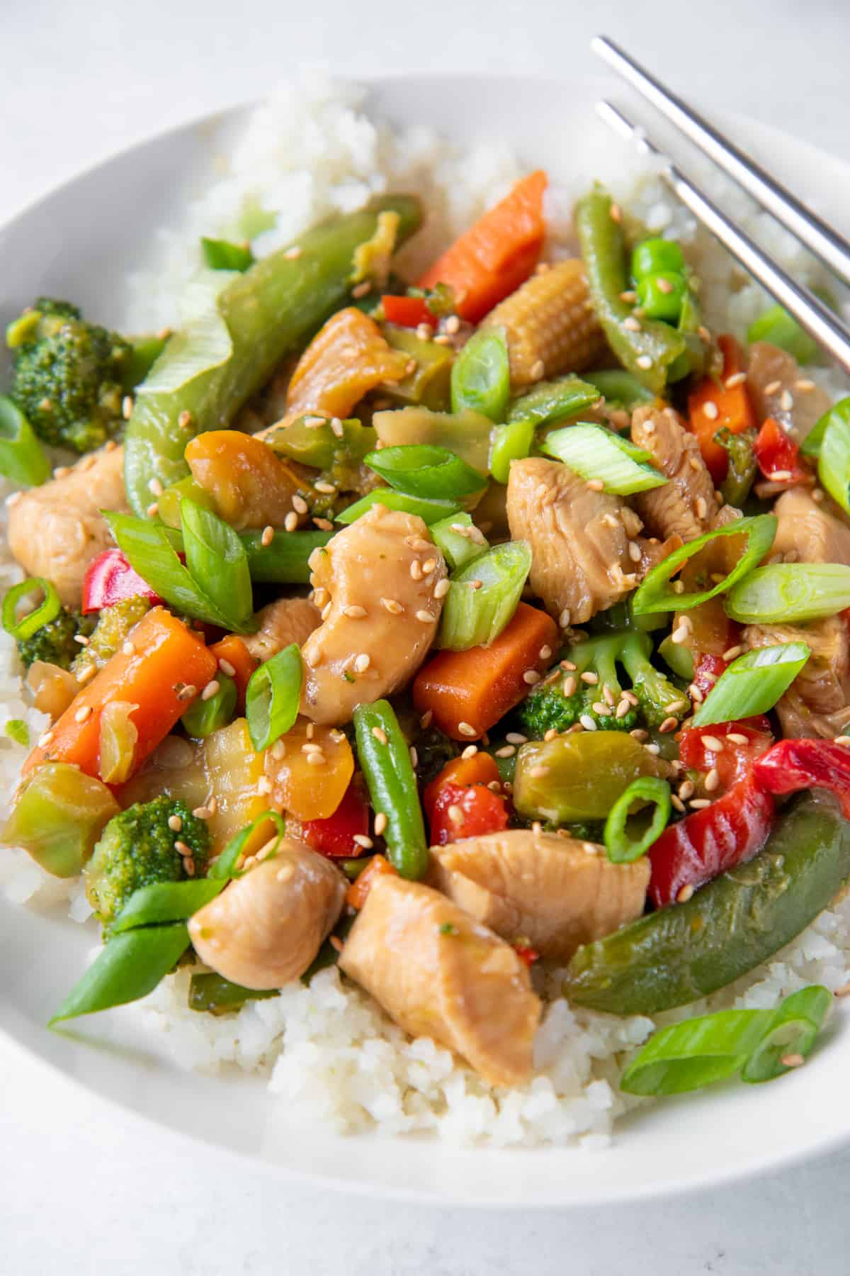 A close up shot of Healthy Chicken Stir Fry sitting in a bowl.