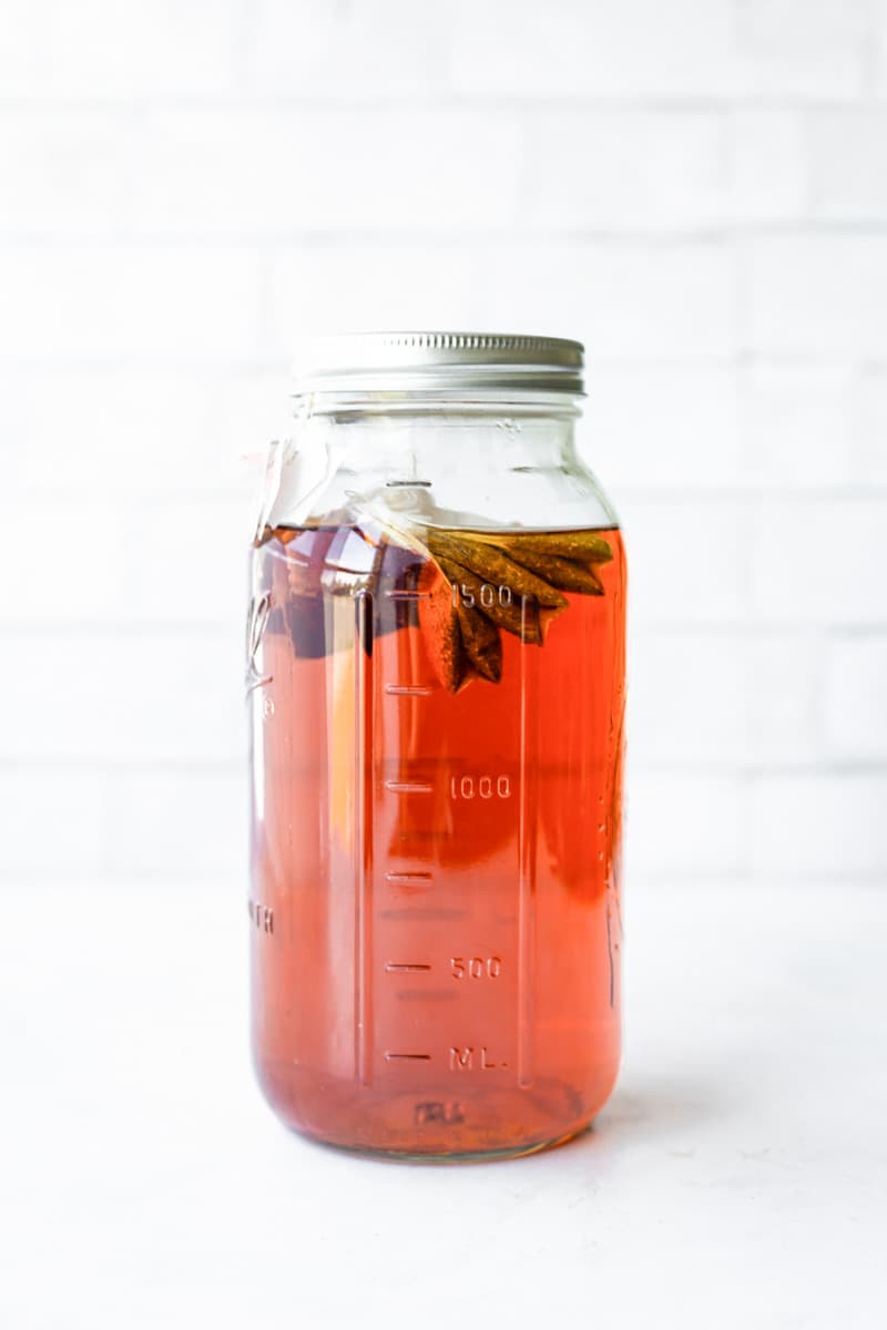 Iced tea in a tall Ball jar with tea bags floating on top.
