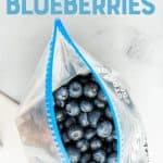 Overhead of individually frozen blueberries in an open freezer bag. A text overlay reads, "How to Freeze Blueberries."