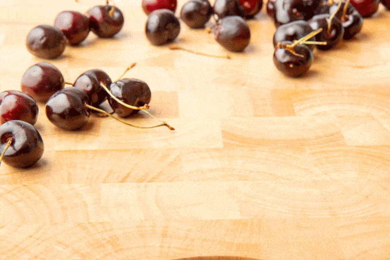 GIF showing how to pit cherries using a metal plain round pastry tip.