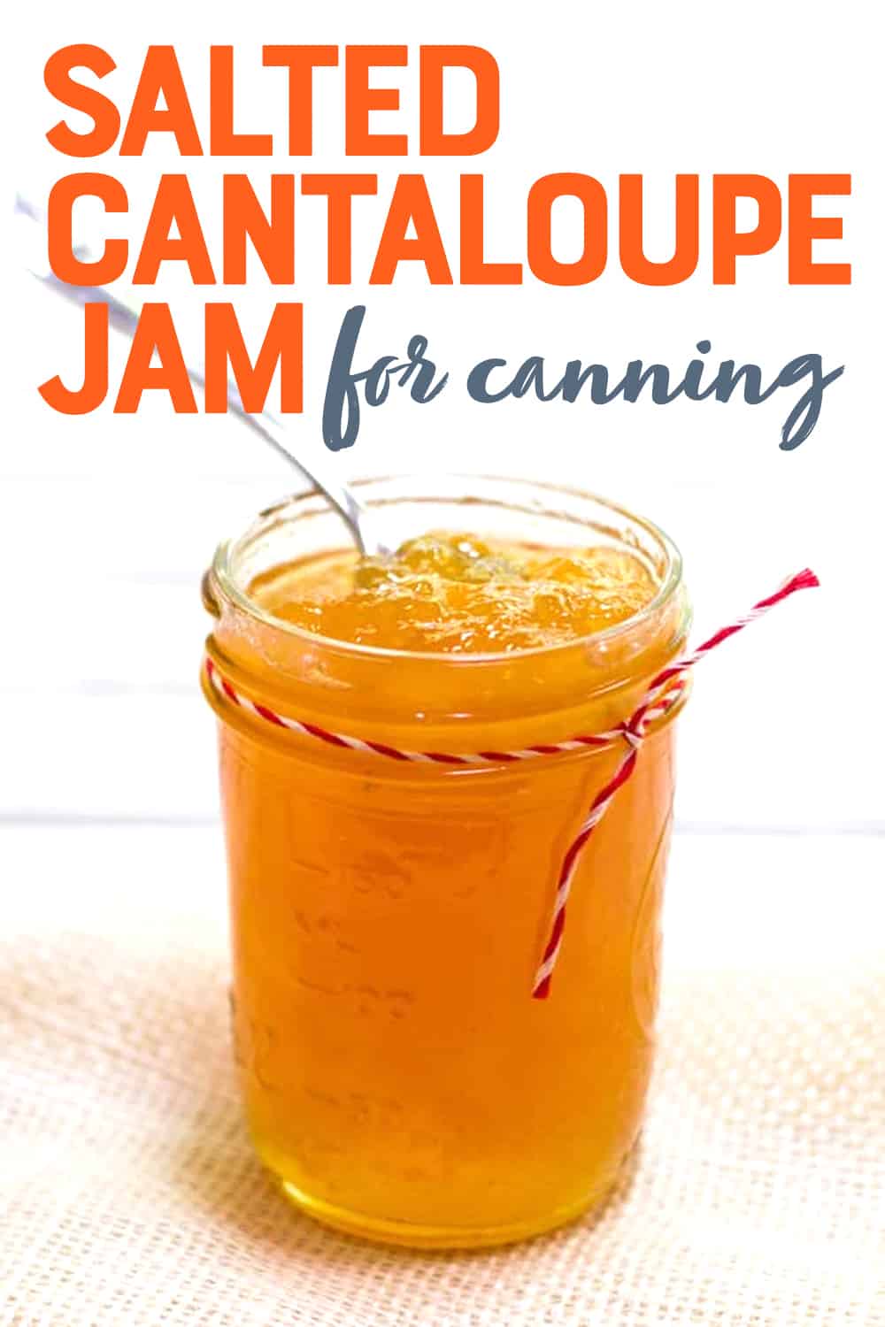 Close-up of pint-sized canning jar full of salted cantaloupe jam. A text overlay reads, "Salted Cantaloupe Jam for Canning."