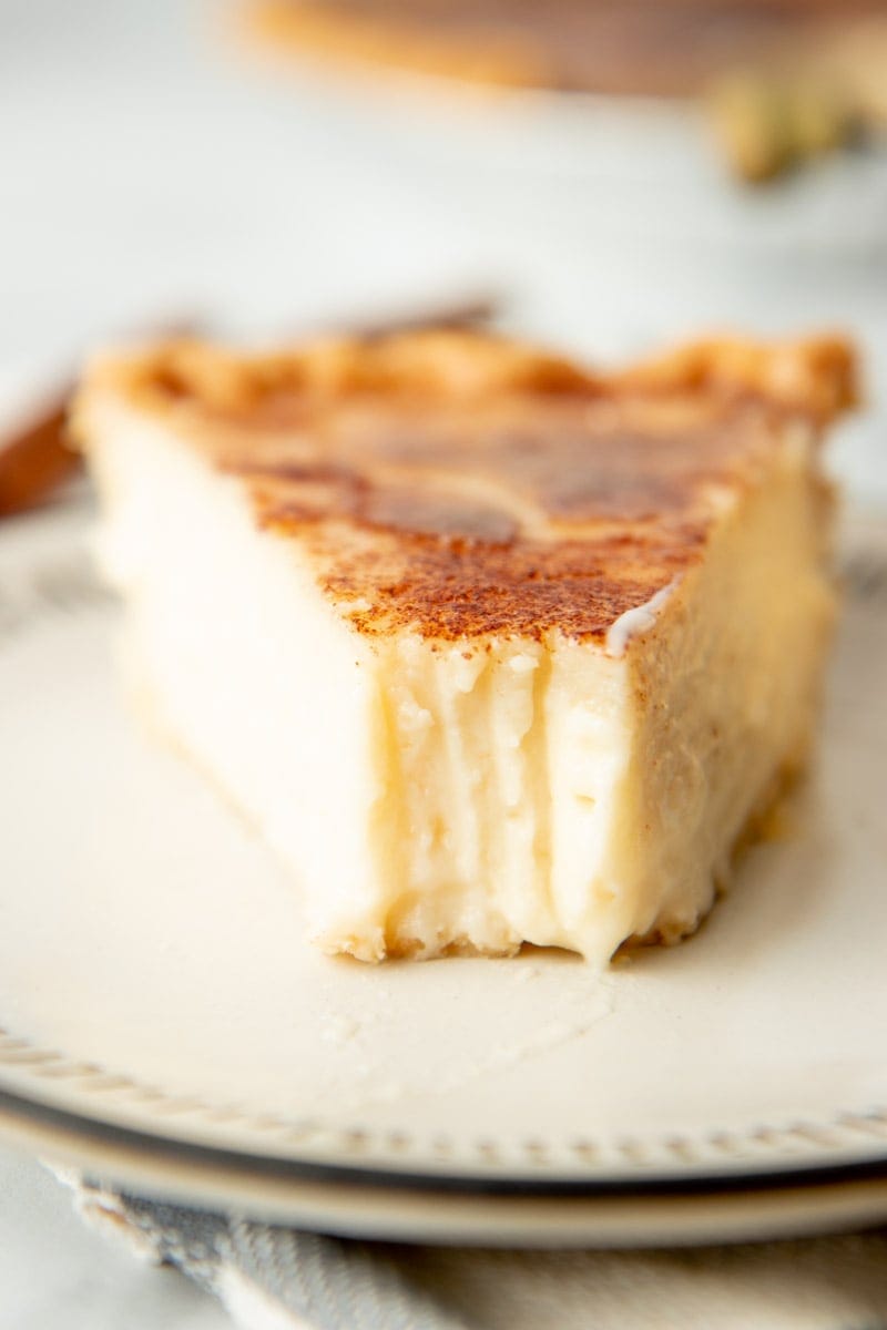 Close-up of a slice of pie with a bite taken out of it.