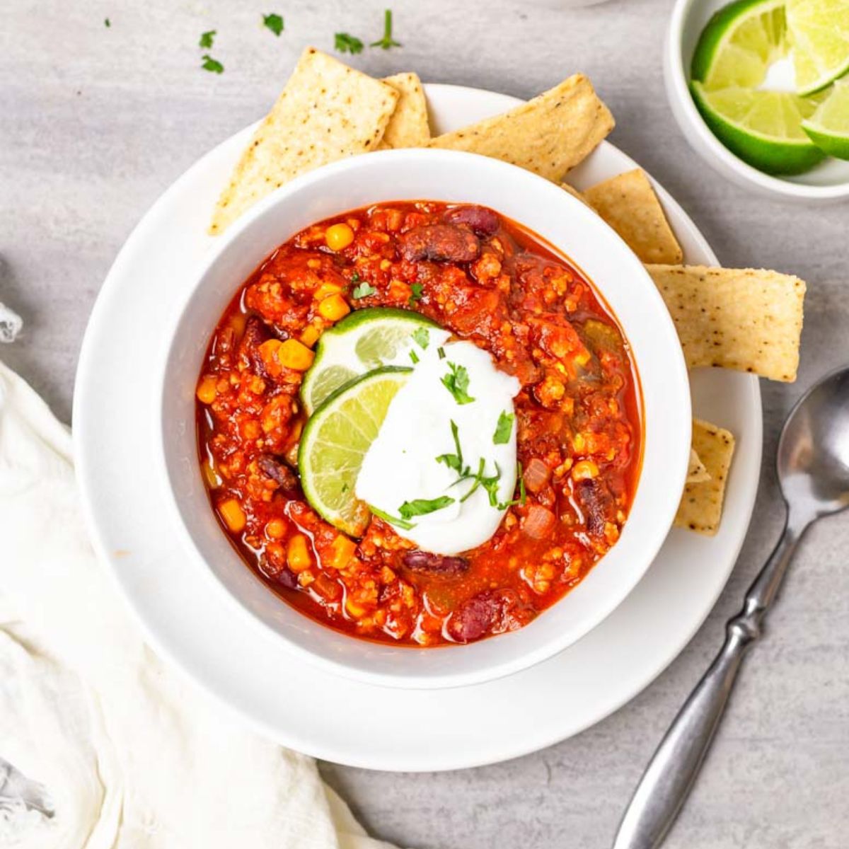 A bowl of taco chili recipe in a white bowl on a gray countertop