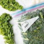 Close-up of frozen kale in a Ziploc freezer bag.