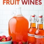 A carboy of strawberry wine with a 3-piece airlock sits beside two flip-top bottles filled with finished fruit wine. A text overlay reads, "How to Make Fruit Wines."