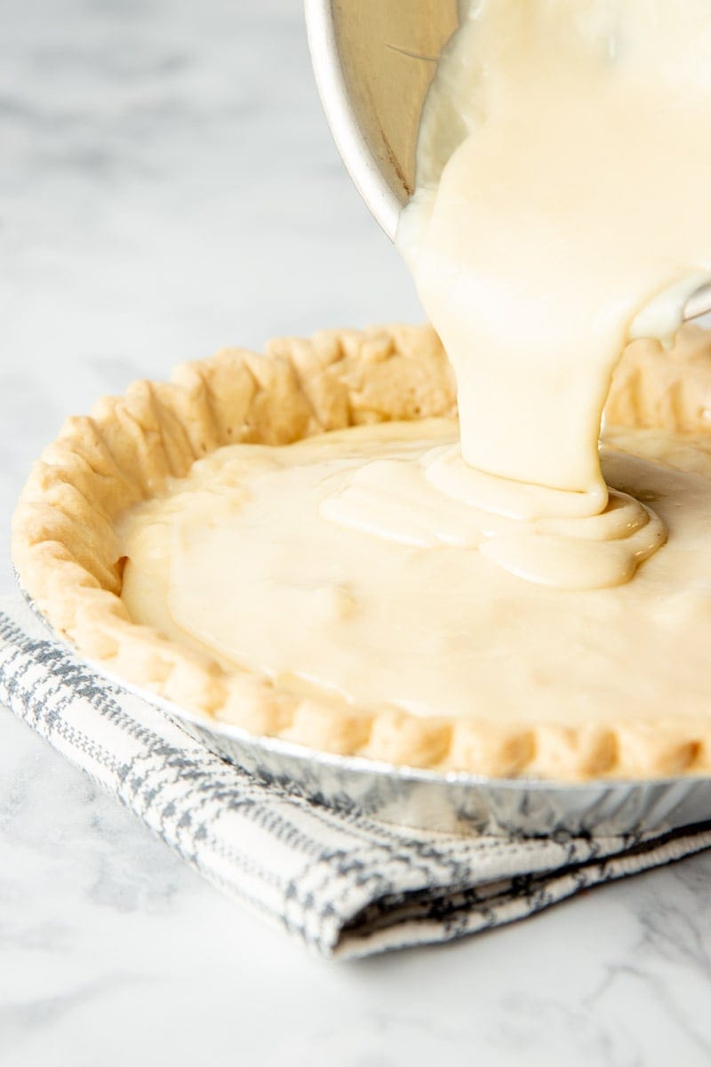 Close-up of pouring sugar pie filling into crust.