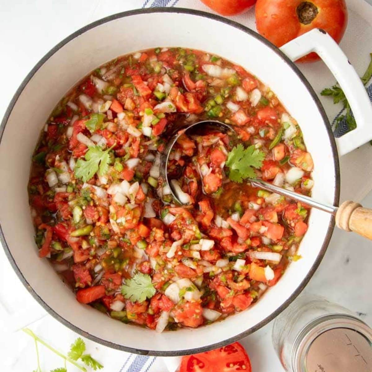 Salsa cooks in a white Dutch oven 