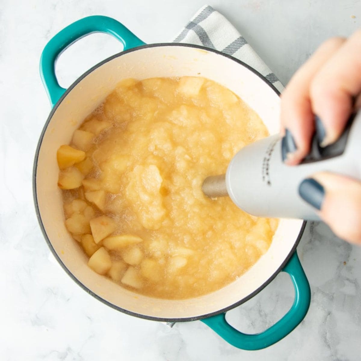 Blending applesauce in a pot with an immersion blender