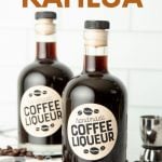 Two bottles of homemade kahlua on a kitchen counter surrounded by coffee beans. A text overlay reads, "Homemade Kahlua."