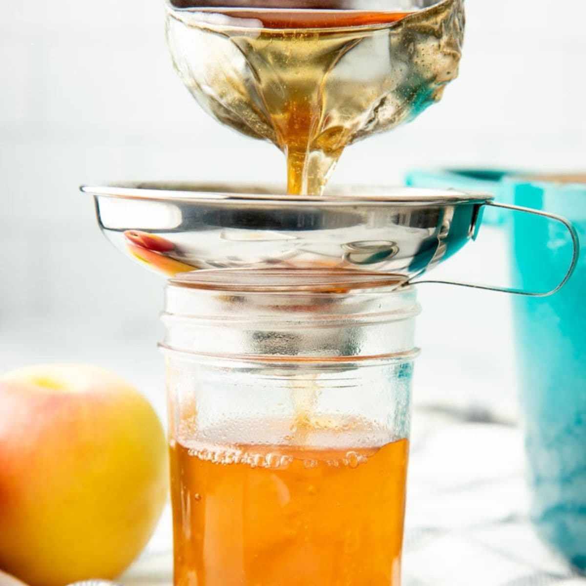 Ladleing hot apple jelly into canning jars