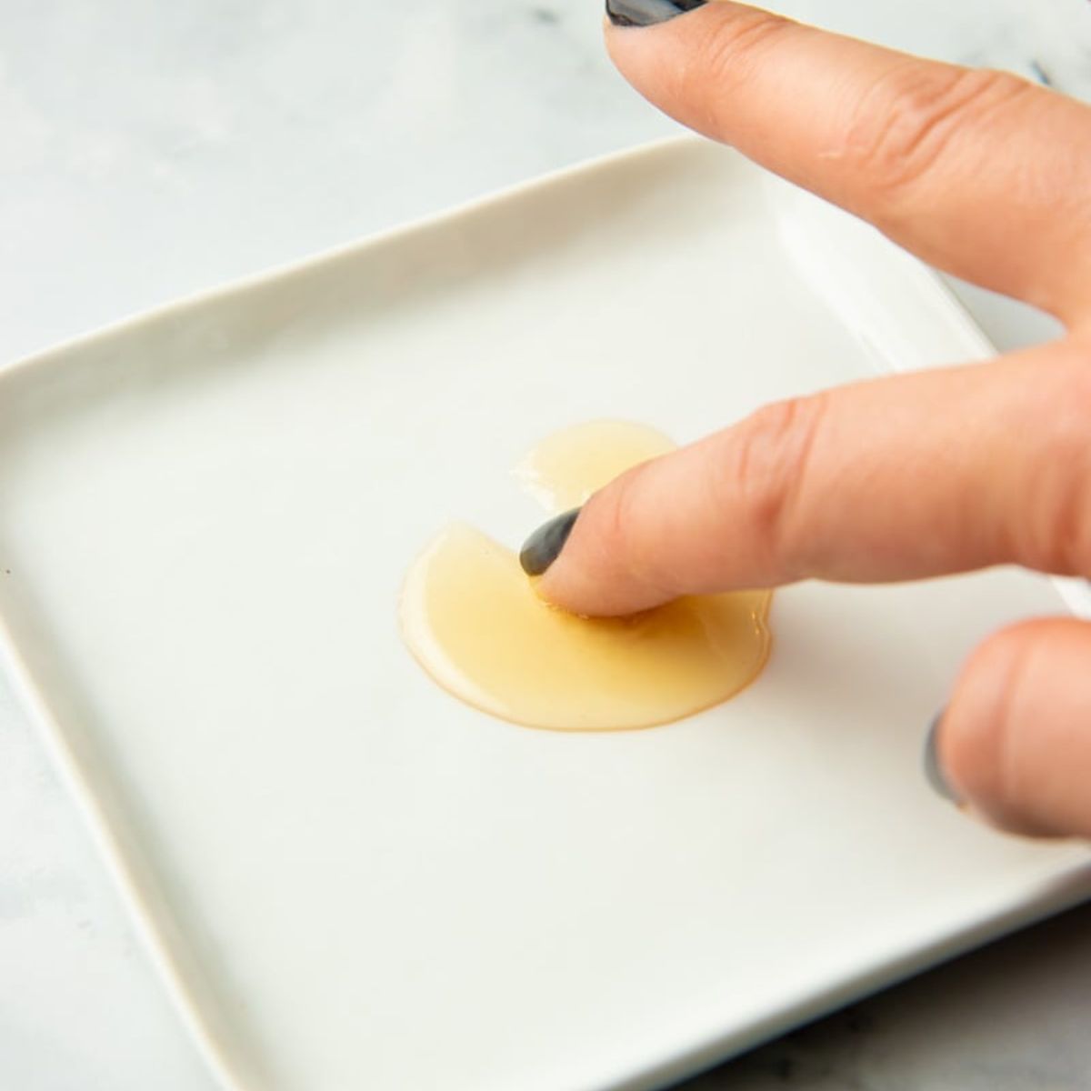 Running a finger through apple jelly to test for get