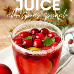 A tumbler filled with jingle juice sits on a table with festive decorations around it. A text overlay reads, "Jingle Juice Christmas Punch."
