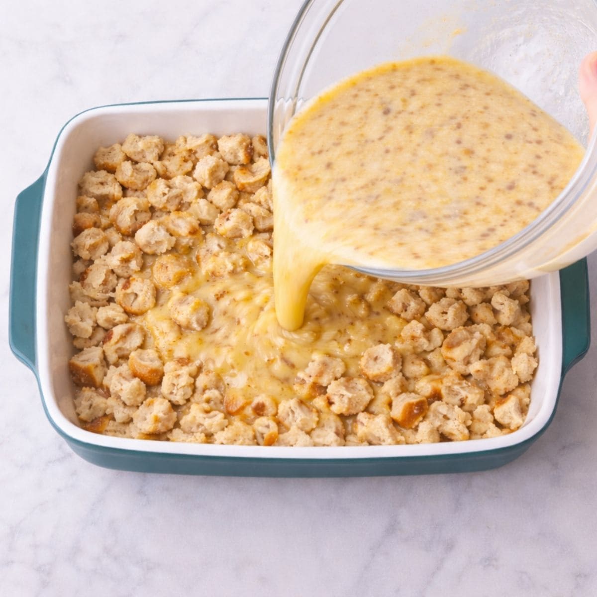 Pouring custard into casserole dish
