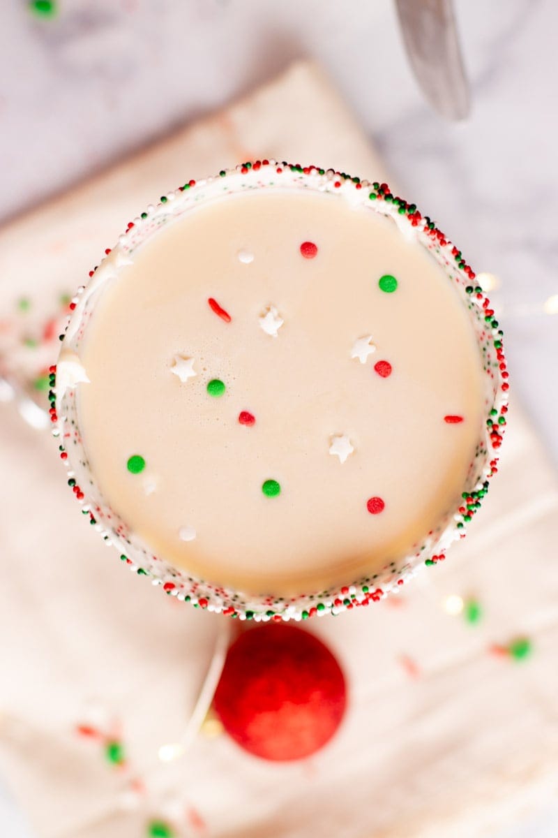 Overhead of sprinkles floating on top of a sugar cookie martini.