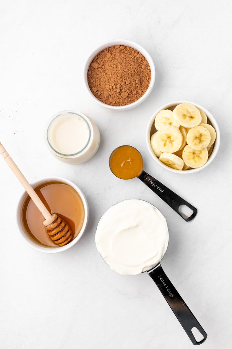 Overhead of the ingredients needed to make a chocolate peanut butter smoothie.