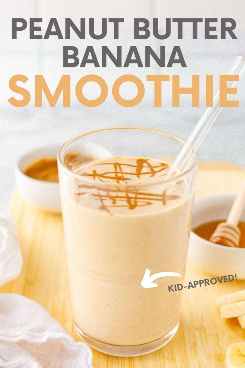 Close-up of smoothie with glass straw on cutting board with fresh ingredients. A text overlay reads, "Peanut Butter Banana Smoothie. Kid-Approved!"