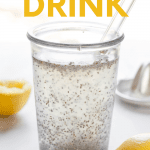Close-up of a glass with chia seeds floating in a mix of water, fresh lemon juice, and apple cider vinegar. A text overlay reads "Chia Seed Drink."