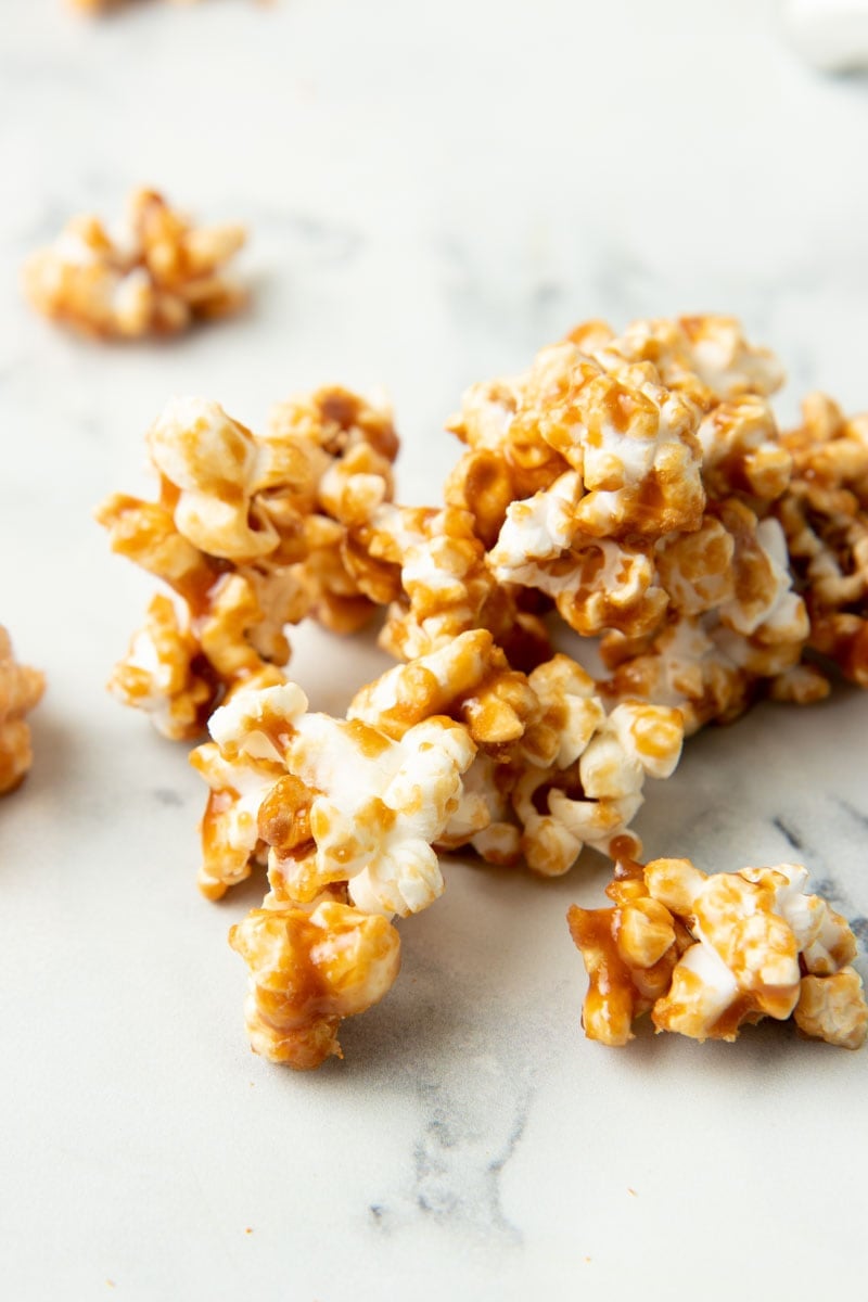 Close-up of finished homemade caramel corn on a marble counter top.