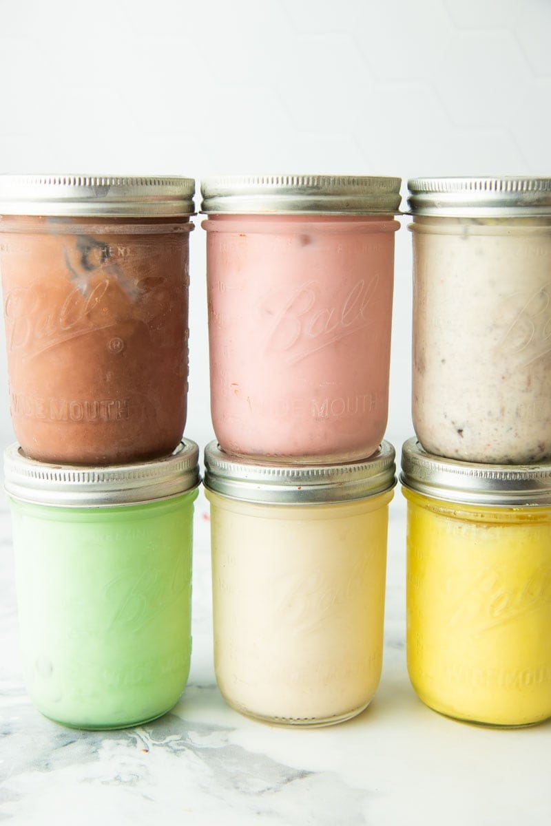 6 mason jars are lined up in stacks of 2. Each jar is filled with a different flavor of mason jar ice cream