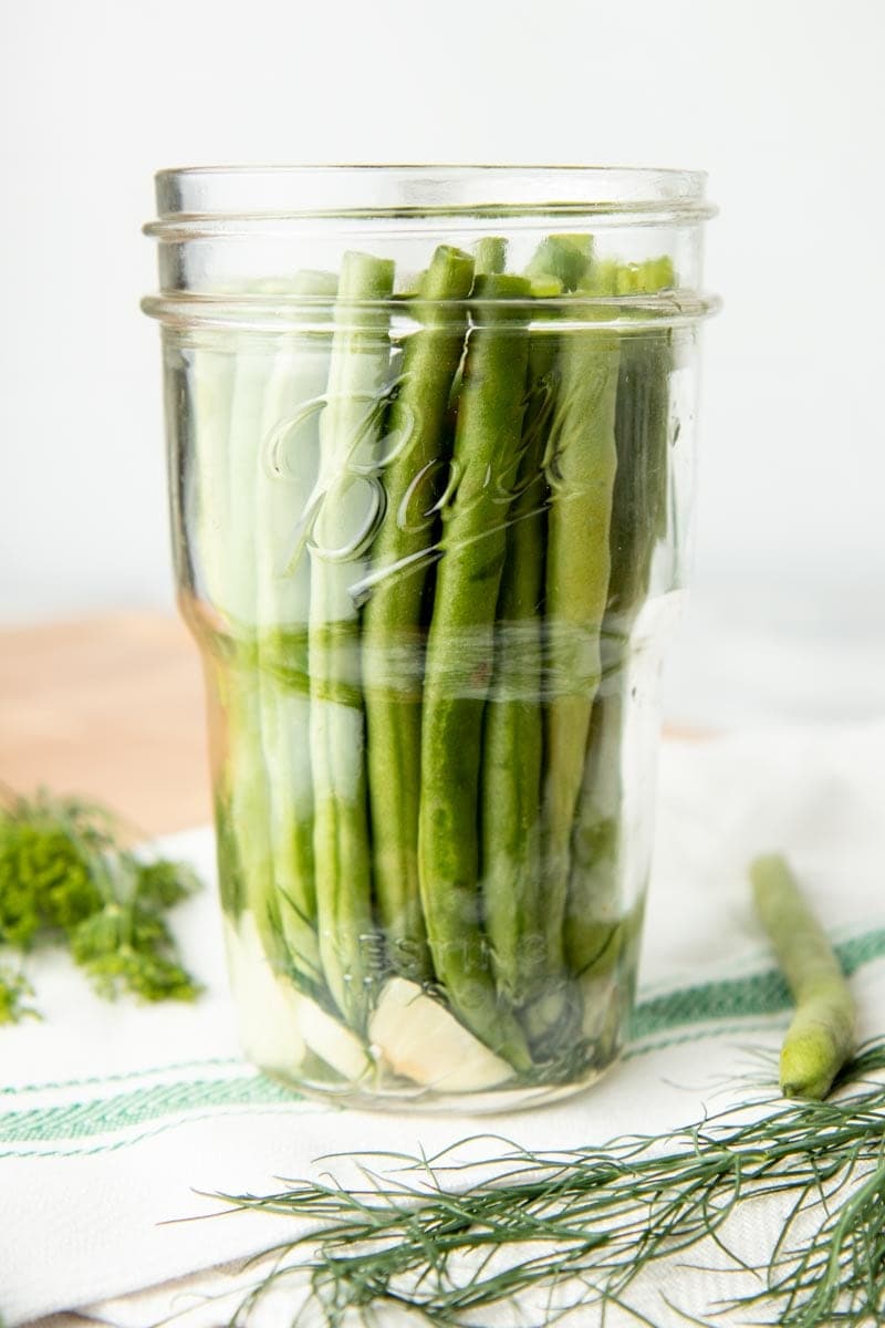 Jar packed with green beans and garlic