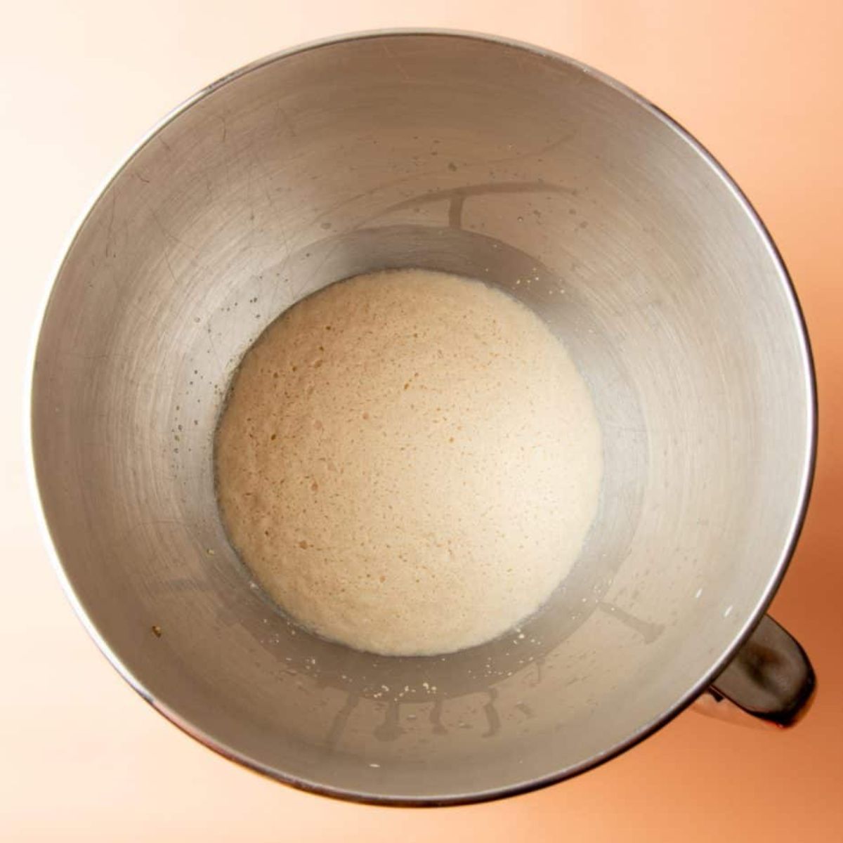 Proofed yeast mixture in the bottom of a stand mixer bowl for easy homemade sandwich bread.