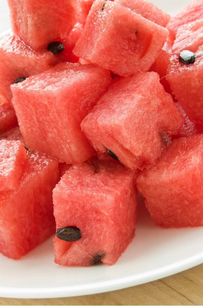 Close up of watermelon cubes piled on a plate.