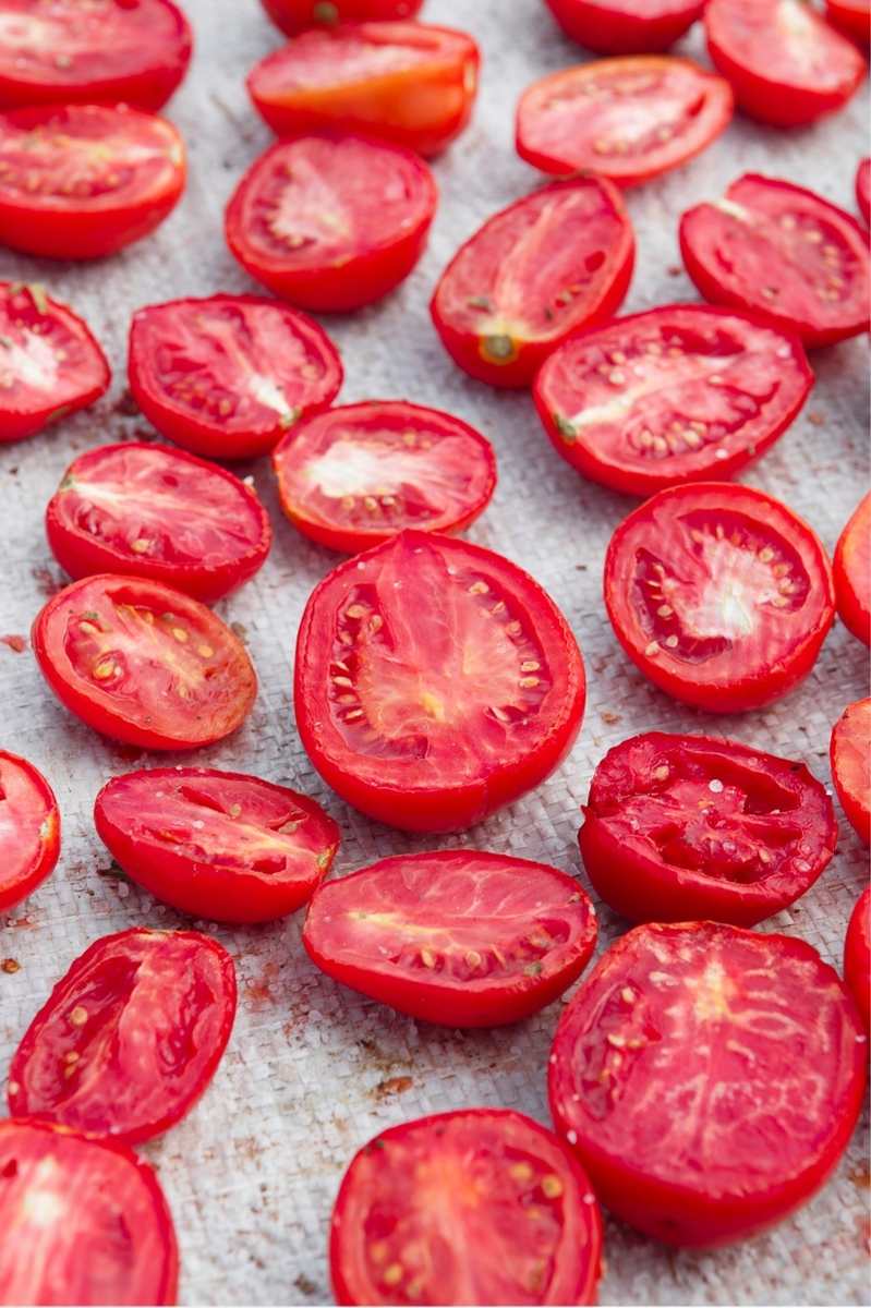 Plum tomatoes halves dehydrating in the sun.
