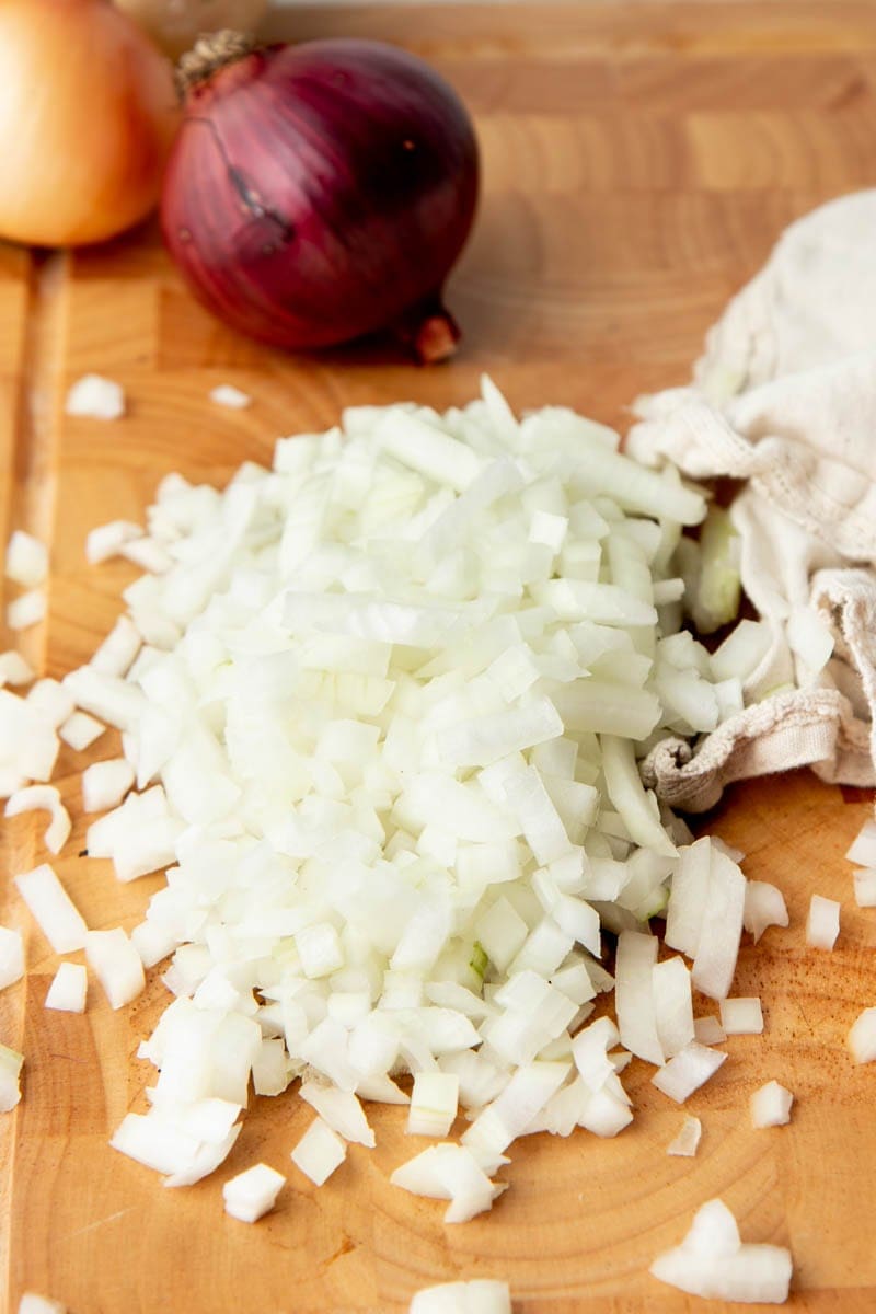 Close-up of diced onions on a cutting board.