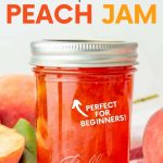 A jar of peach jam sits on a folded dishtowel, surrounded by fresh peaches. A text overlay reads "How to Can Peach Jam. Perfect for Beginners!"