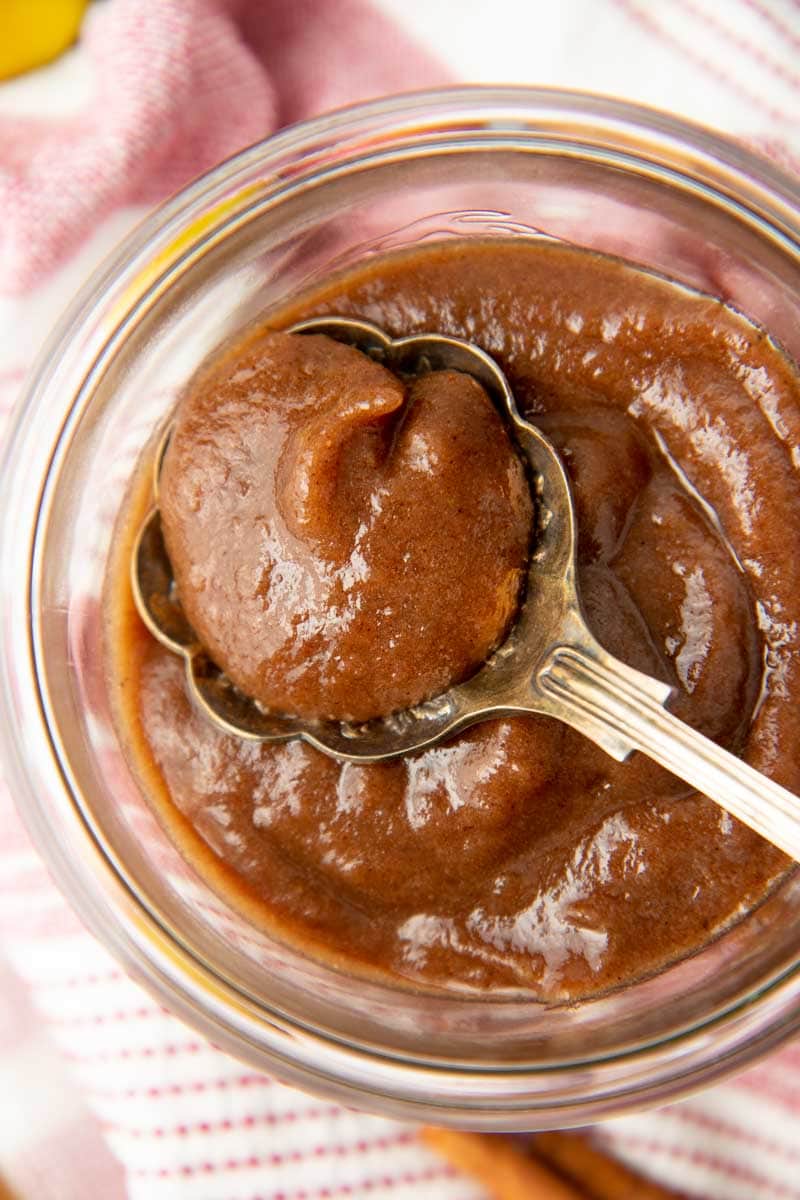 Close-up of a spoonful resting atop a full jar.